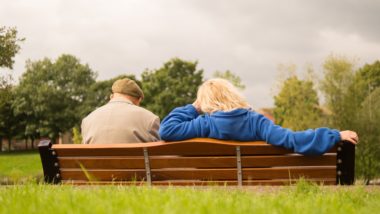 senior couple sitting on bench